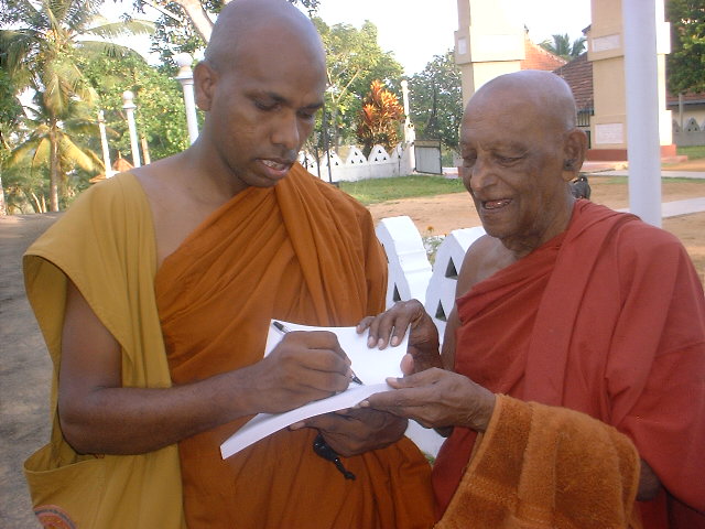 giving  a credential book to Devamitta thero at Baddegama temple on 03 June 2006.JPG